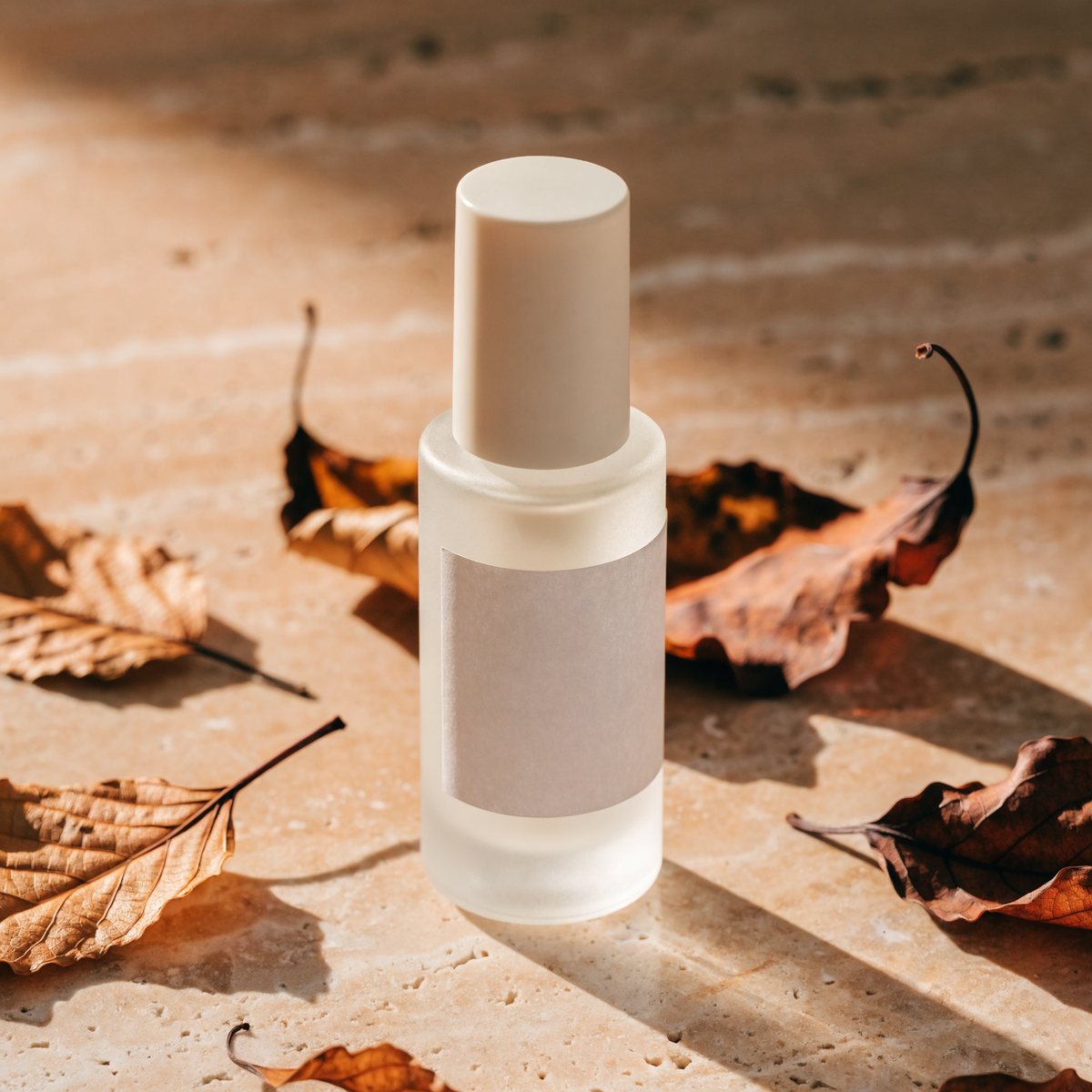 Serum bottle styled for autumn with amber leaves